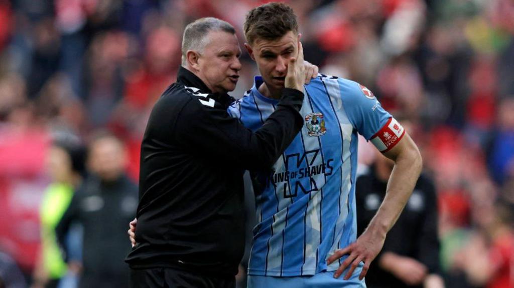 Mark Robins consoles Coventry City captain Ben Sheaf after the team lost on penalties to Manchester United in last season's the FA Cup semi-finals