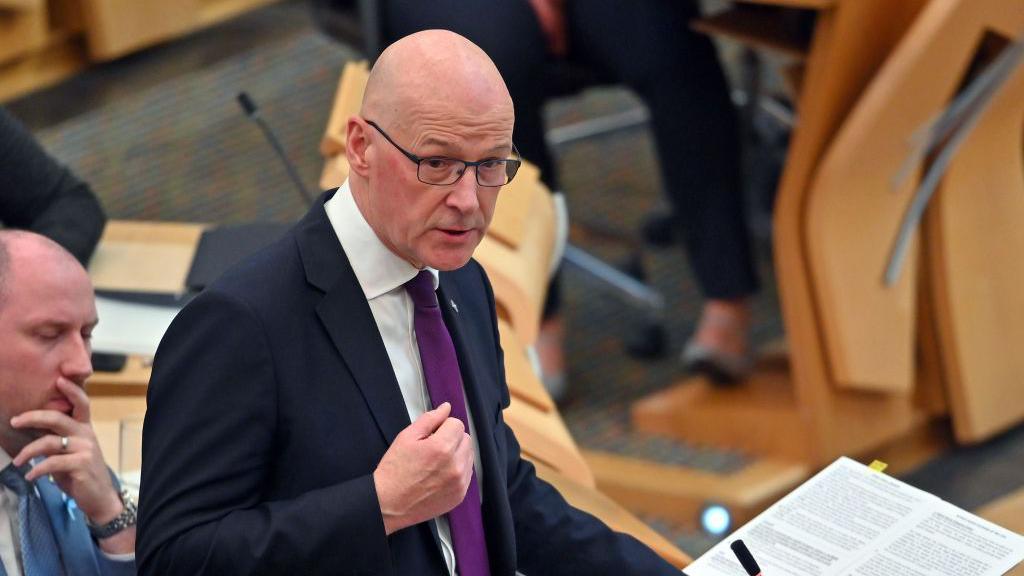 John Swinney speaking at Holyrood