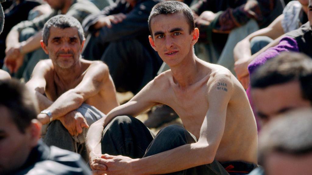 Emaciated prisoners at a Bosnian Serb camp in 1992