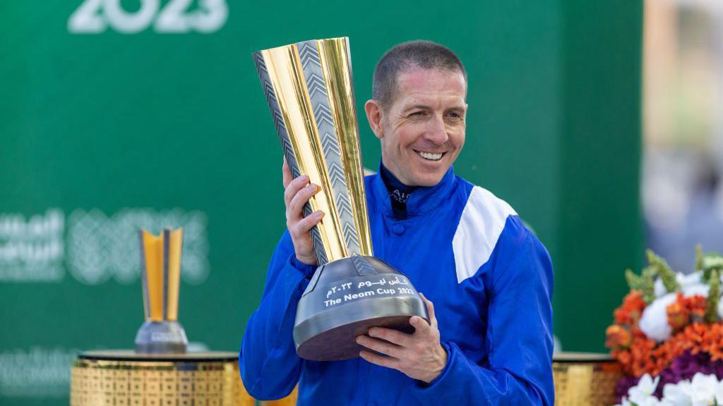 Jim Crowley with the trophy after riding Mostahdaf to victory at the Neom Turf Cup in Saudi Arabia in February 2023