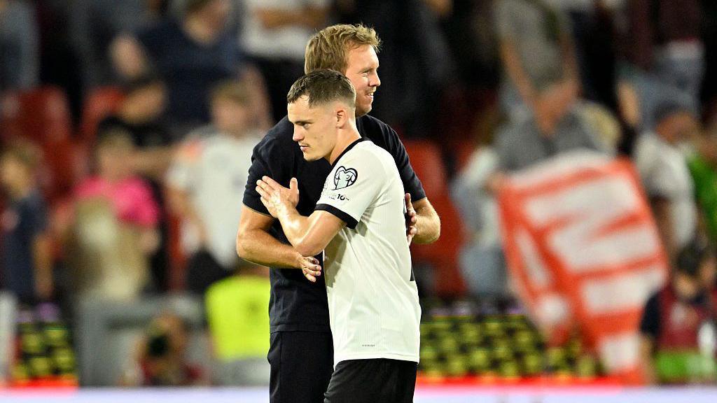 Germany manager Julian Nagelsmann and Florian Wirtz hugging.