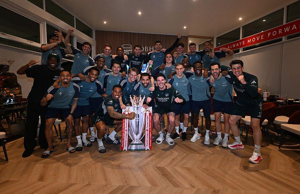 Arsenal players pose with a cutout of the Premier League trophy