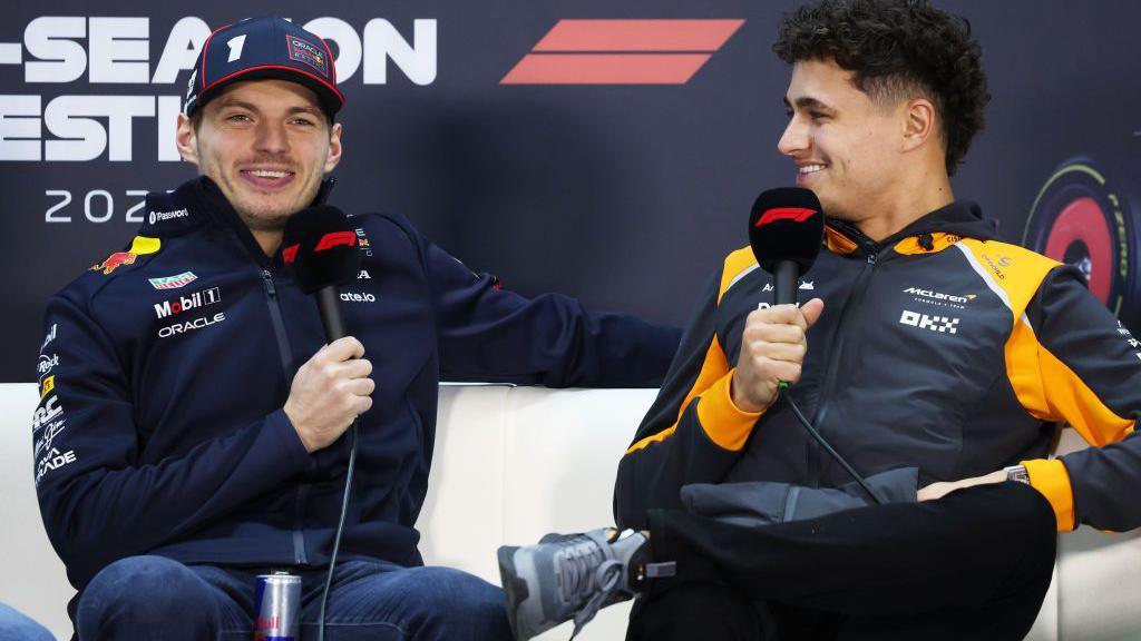 Max Verstappen and Lando Norris hold microphones in the news conference in Bahrain 