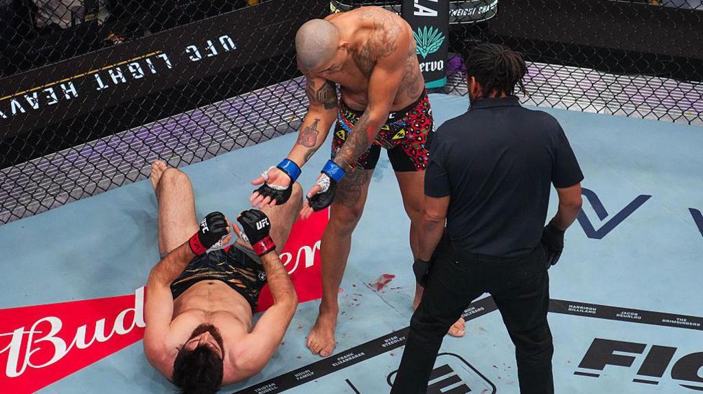 Alex Pereira celebrating with Magomed Ankalaev on the canvas 