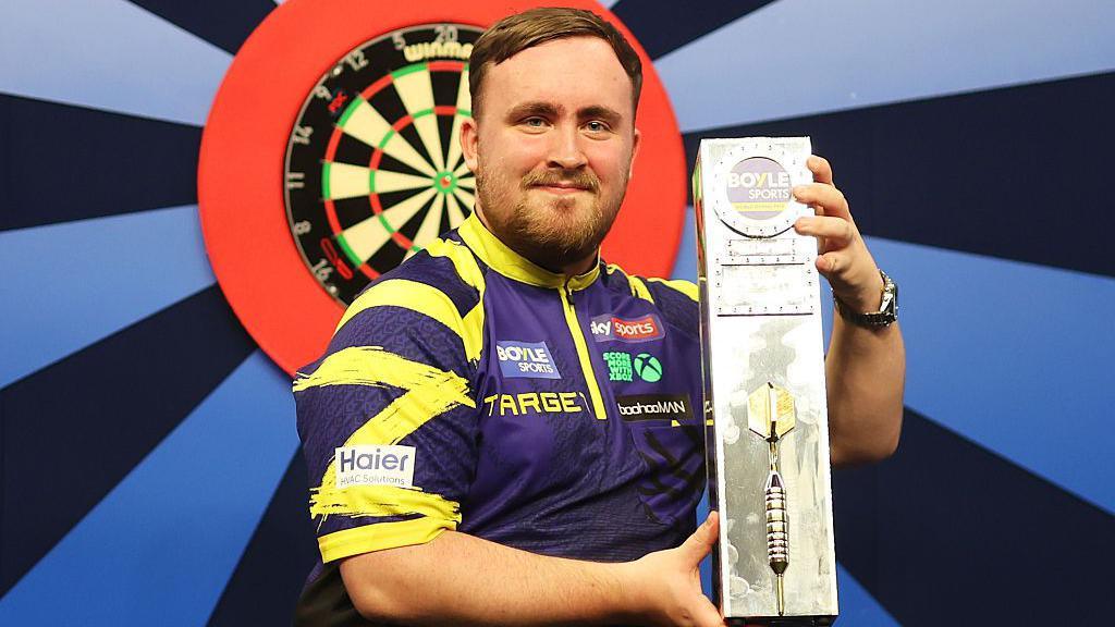 Luke Littler with the World Grand Prix trophy