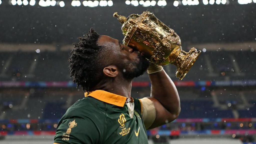 South Africa captain Siya Kolisi kisses the Rugby World Cup trophy
