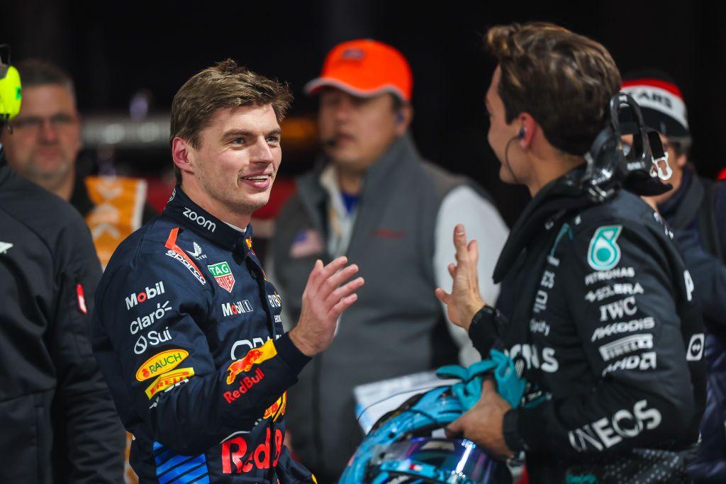 Max Verstappen shakes hands with George Russell to congratulate him on achieving pole position for the Las Vegas Grand Prix