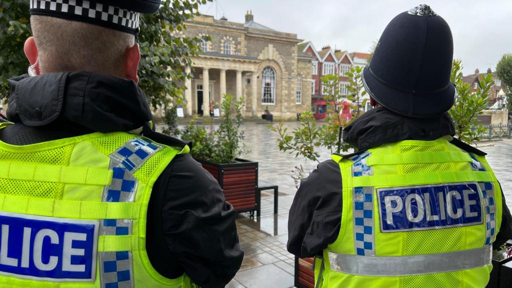 Two police officers stood outside the Guildhall