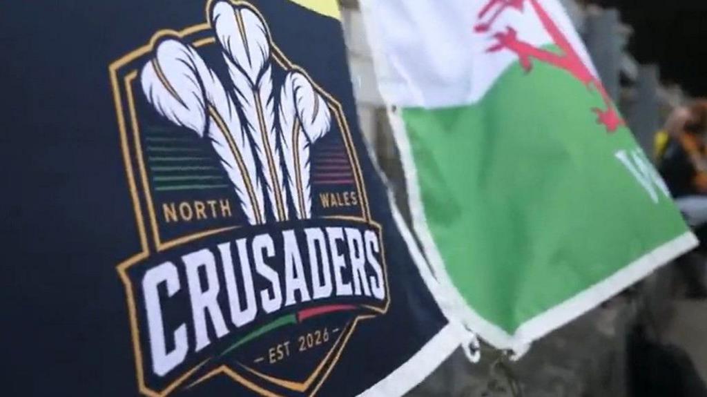 North Wales Crusaders flag alongside Welsh dragon flag
