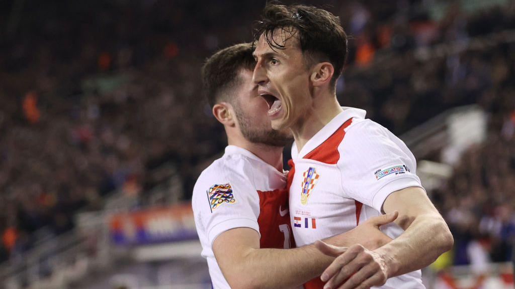 Ante Budimir celebrates scoring for Croatia against France