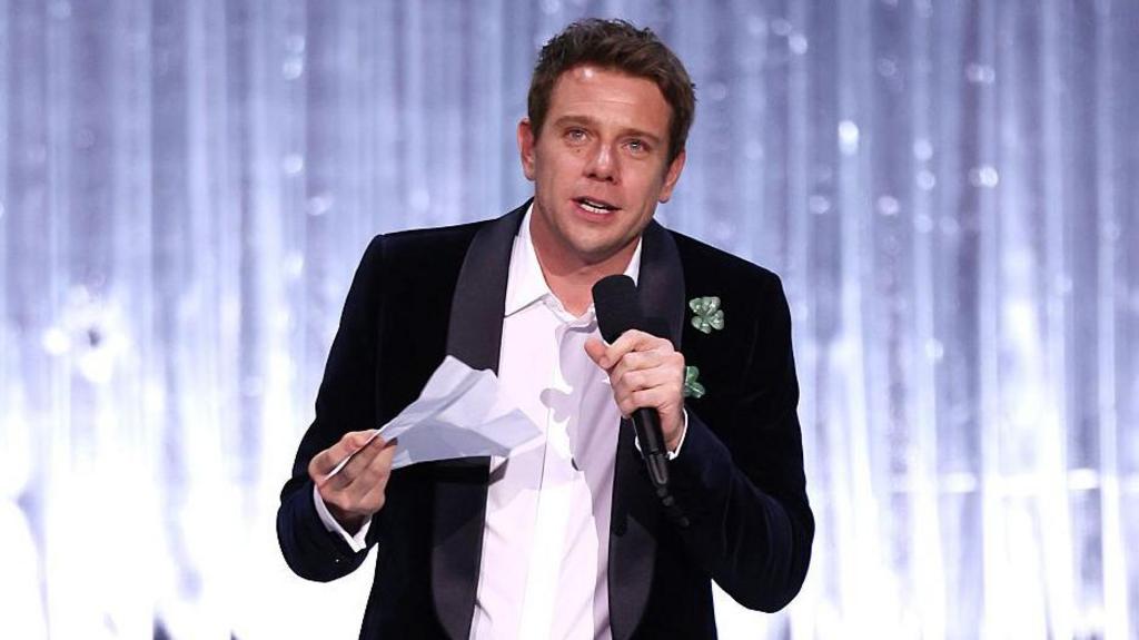 Jonathan Anderson reading out his accpetance speech