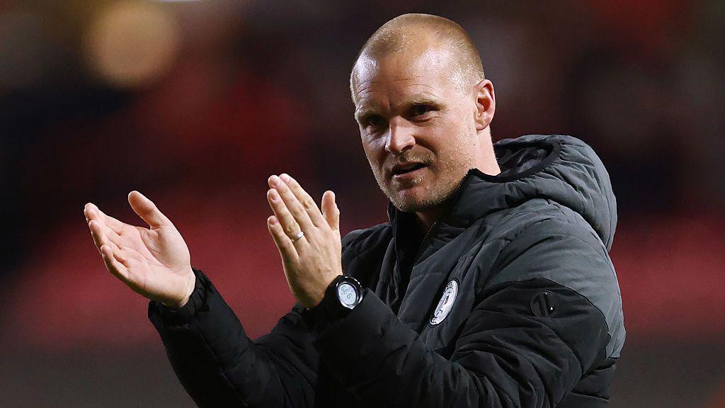Liam Manning applauds Bristol City fans at full-time