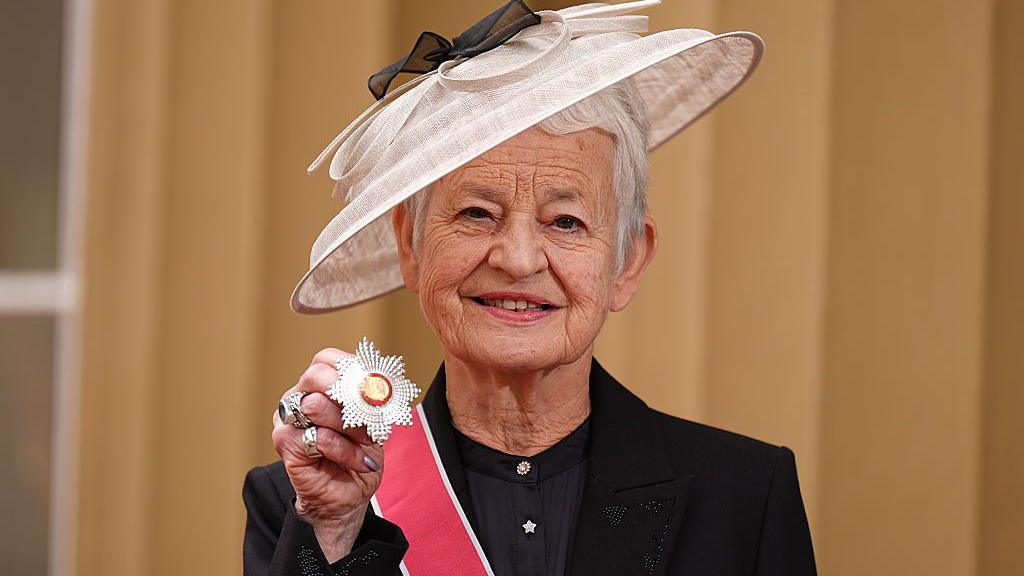 Jacqueline Wilson posing with her Grand Cross at Buckingham Palace