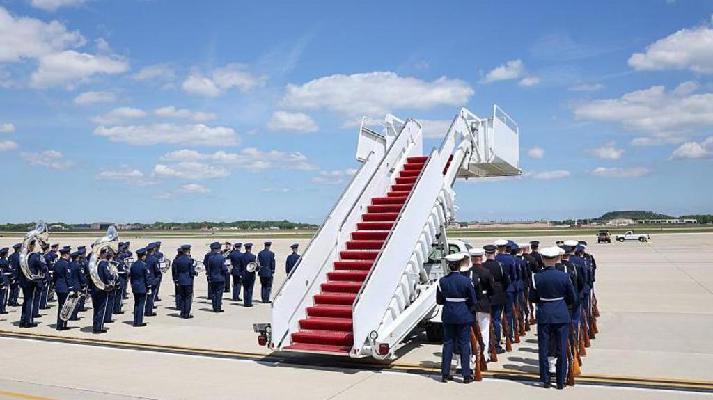  The U.S. Army band and honor guard prepare ahead of the arrival of King Charles III and Queen Camilla, floating stairs next to them.
