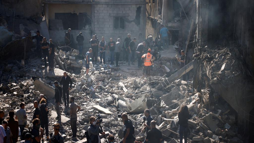 Rescuers search for survivors at the site of an Israeli strike near Rafik Hariri University Hospital,