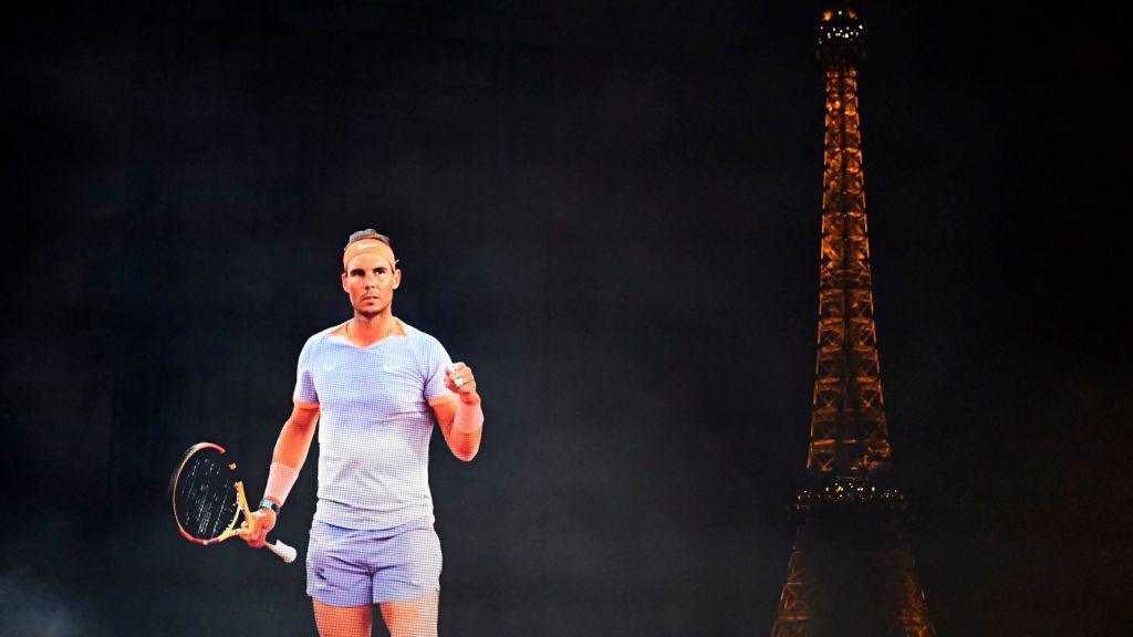 An image of Rafael Nadal is projected into the night sky in Paris, with the Eiffel Tower in the background