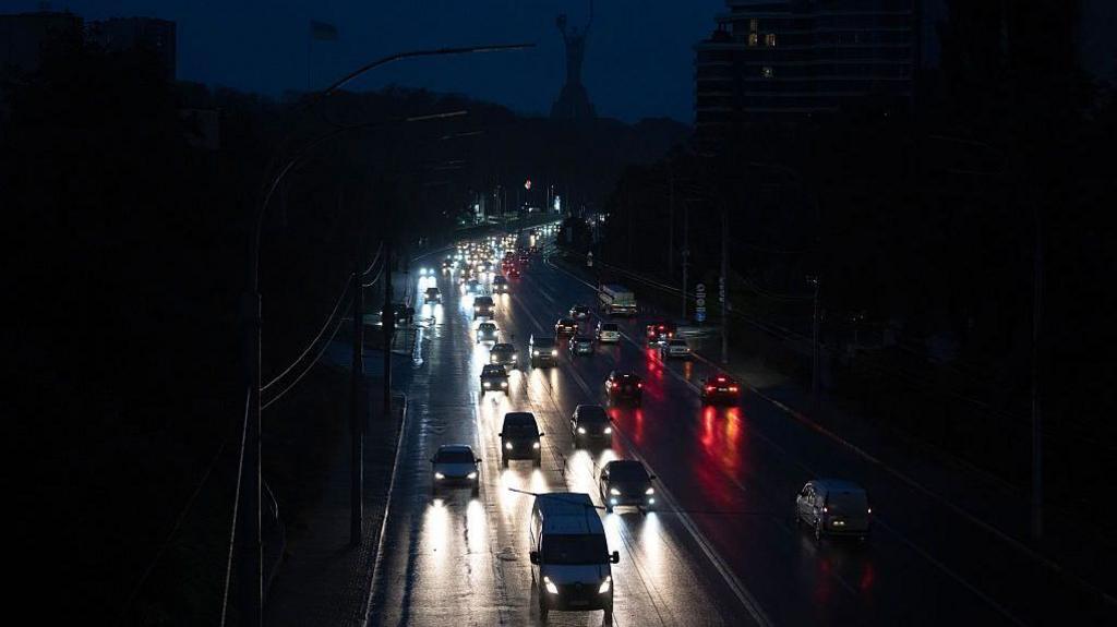 Vehicle lights illuminate a motorway in Kyiv during a partial blackout caused by Russian strikes. Photo: 10 October 2025