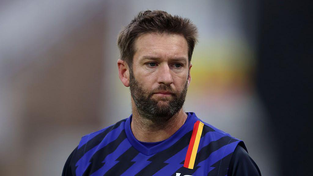 Andrew Tye looks on