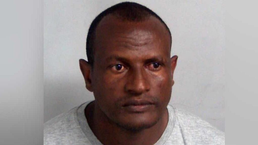 Hadush Kebatu in a grey sweater looking at camera.