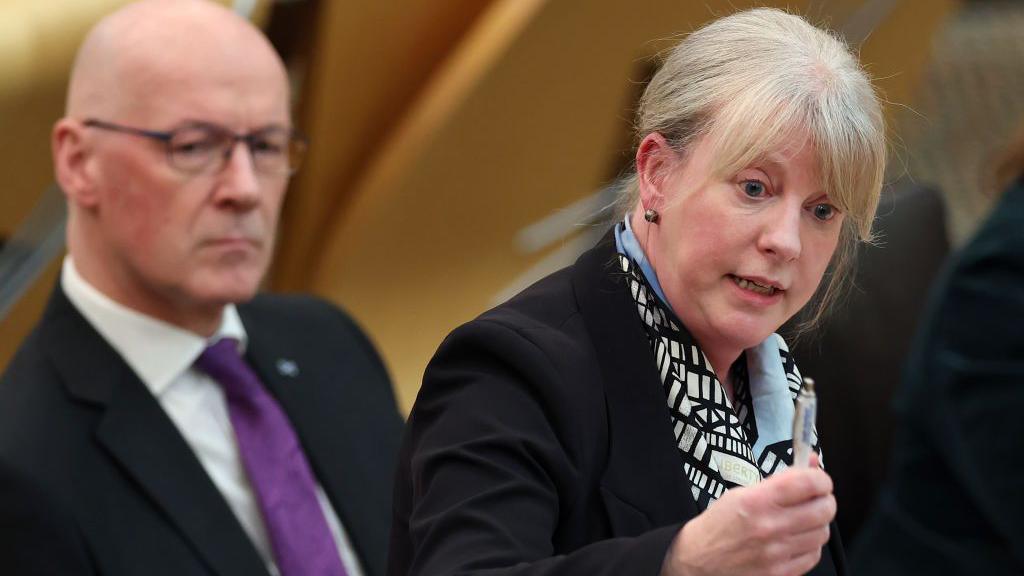 Shona Robison and First Minister John Swinney at the Scottish Parliament.