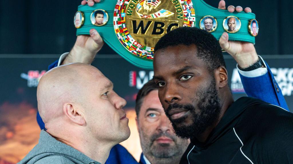 Lukasz Rozanski stares at Lawrence Okolie, who looks away