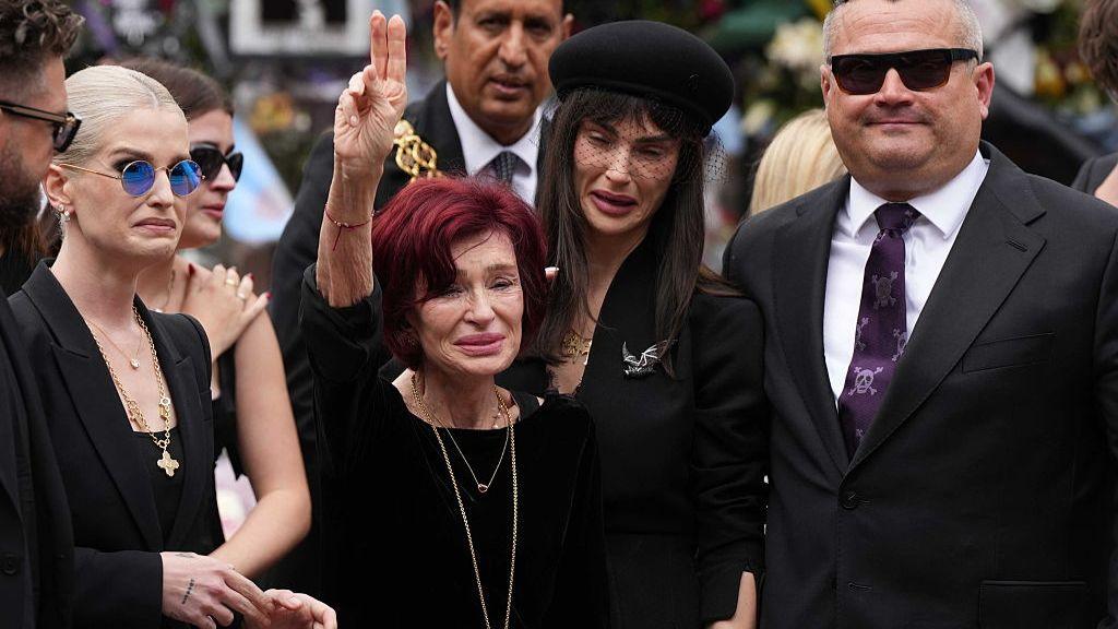 Sharon Osbourne raises her hand in a peace sign during the funeral ceremony of her late husband Ozzy Osbourne in Birmingham on 30 July 2025.