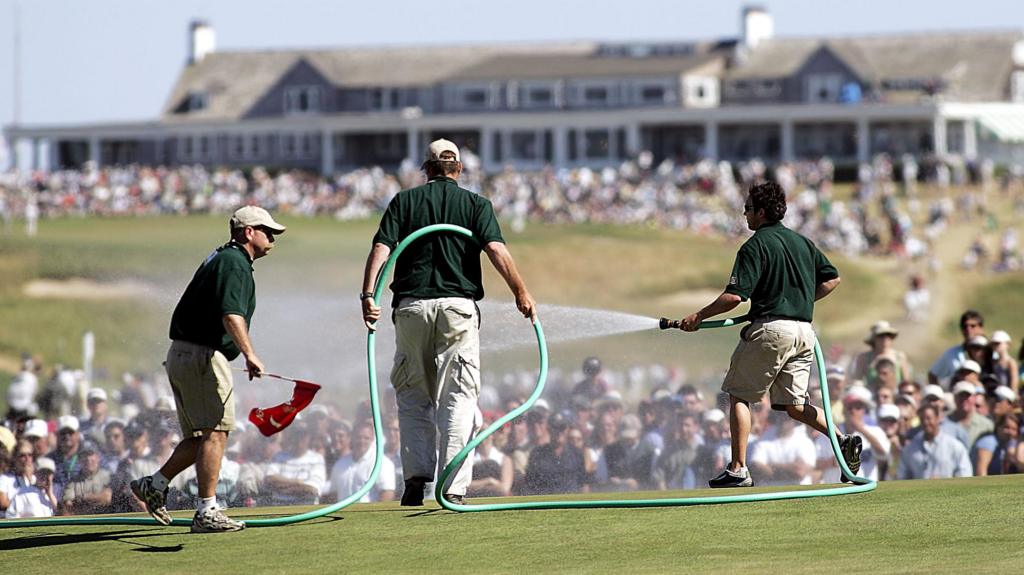Greenstaff watering the par-three seventh green during the final round of the 2004 US Open at Shinnecock Hills, New York.