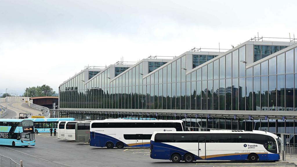 A number of buses line up outside Belfast's new Grand Central Station, a modern glass building