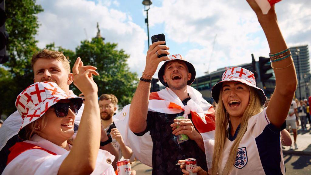 England fans cheer for their team as they gather near Trafalgar Square