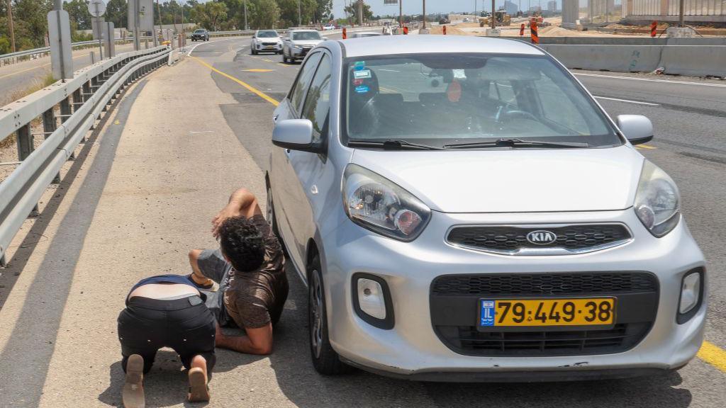 Israelis take cover during rocket fire from the Gaza Strip near the city of Herzliya on May 26, 2024, amid the ongoing conflict between Israel and the Palestinian militant group Hamas.