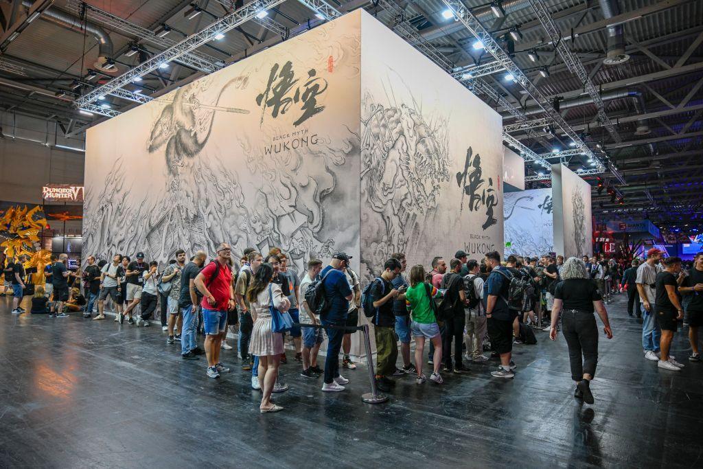 A long queue snakes around a promotional partition in a large warehouse