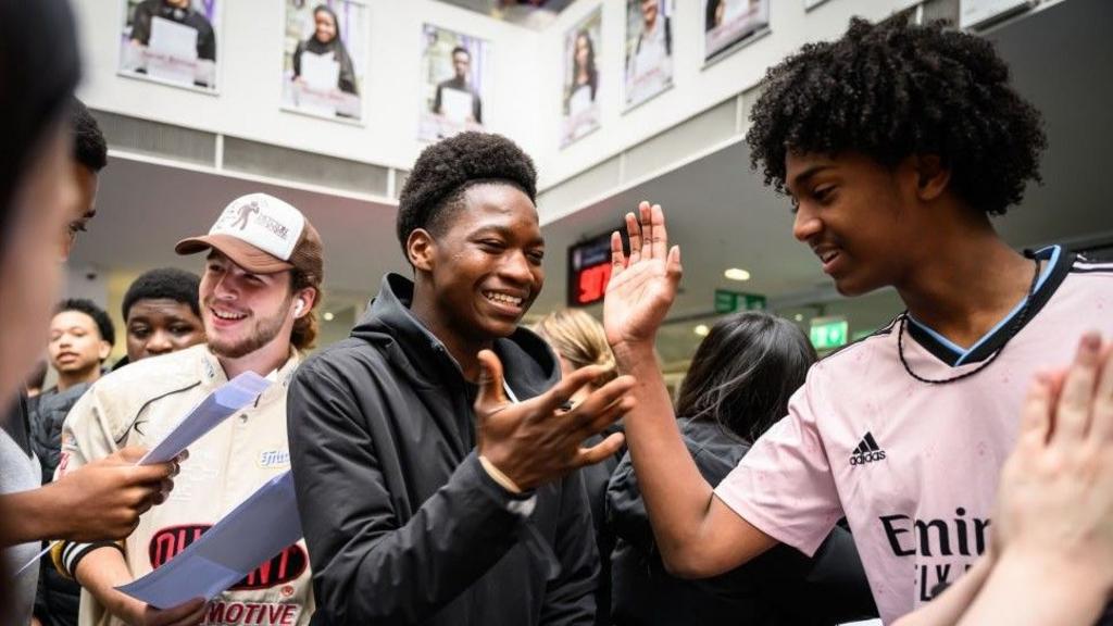 Students react after opening their GCSE results at the City of London Academy Southwark