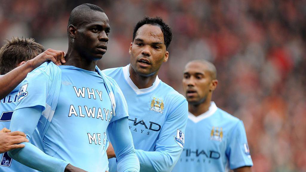 Mario Balotelli with a shirt saying "Why always me?"