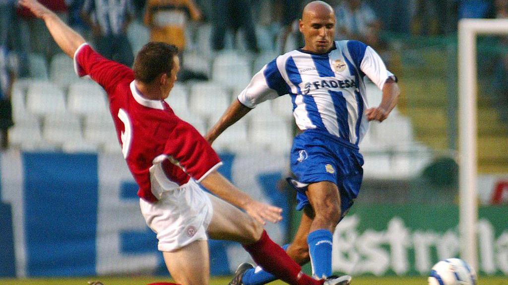 Shelbourne's David Crawley slides in to tackle Deportivo's Manuel Pablo