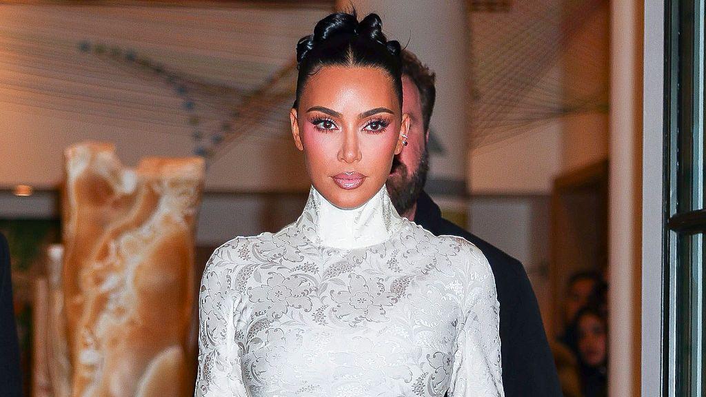 US reality star Kim Kardashian in a white dress with long sleeves and turtle neck.