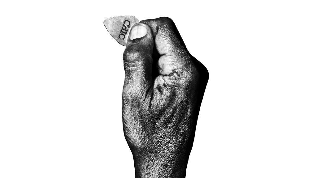 A black and white picture of Nile Rodgers' hand holding a plectrum