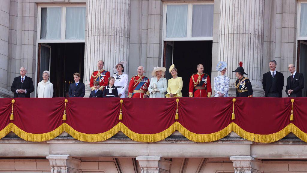 The Royal Family on the balcony of Buckingham Palace for the Trooping of the Colour parade - The King and Queen can be seen, along with Prince William and Princess Kate who are with their children - other royals are also on the balcony. All are in ceremonial dress. 