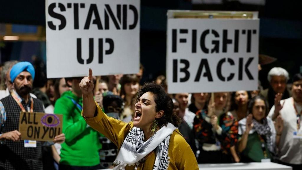 Activists shout slogans during a protest action at the COP29 United Nations climate change conference