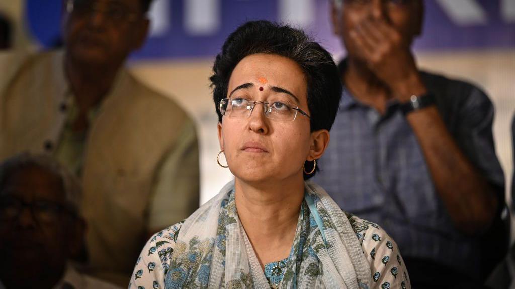 NEW DELHI, INDIA - JUNE 22: Atishi, Delhi Water Minister seen along CPI leader D Raja and AAP leader Sanjay Singh during the 2nd Day of "Pani Satyagrah" against the Haryana Government at Bhogal, Jangpura on June 22, 2024 in New Delhi, India. The water minister said that Delhi depends on neighbouring states for water. It receives 1,005 MGD water from neighbouring states through rivers and canals, out of which Haryana provides 613 MGD, she said. In the extreme summer heat faced by Delhi, Haryana has reduced its share to 513 MGD for a few weeks affecting over 28 lakh people, she added. (Photo by Sanchit Khanna/Hindustan Times via Getty Images)