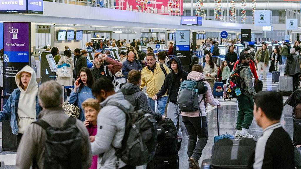 Travelers in Terminal One at O'Hare International Airport (ORD) in Chicago, Illinois, US, on Friday, Nov. 7, 2025