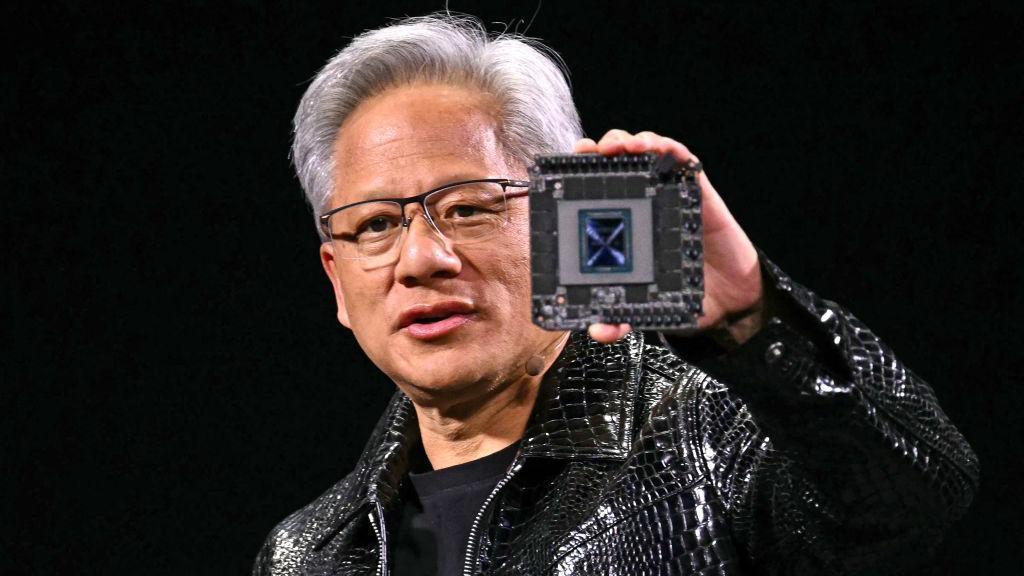 Nvidia CEO Jensen Huang delivers a keynote address at the Consumer Electronics Show while holding a Nvidia chip