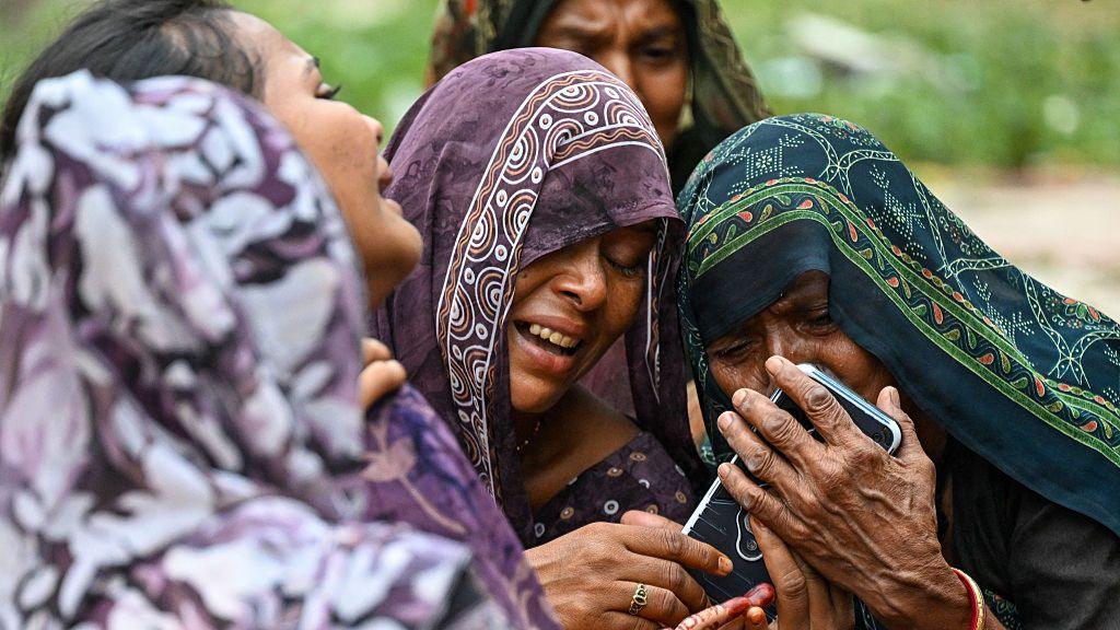 Relatives mourn the death of Akash Patni, a 14-year-old boy who was sleeping on the ground when Air India flight 171