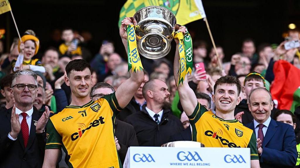 Michael Langan and Shane O'Donnell raise the Mícheál Ó Muircheartaigh Cup