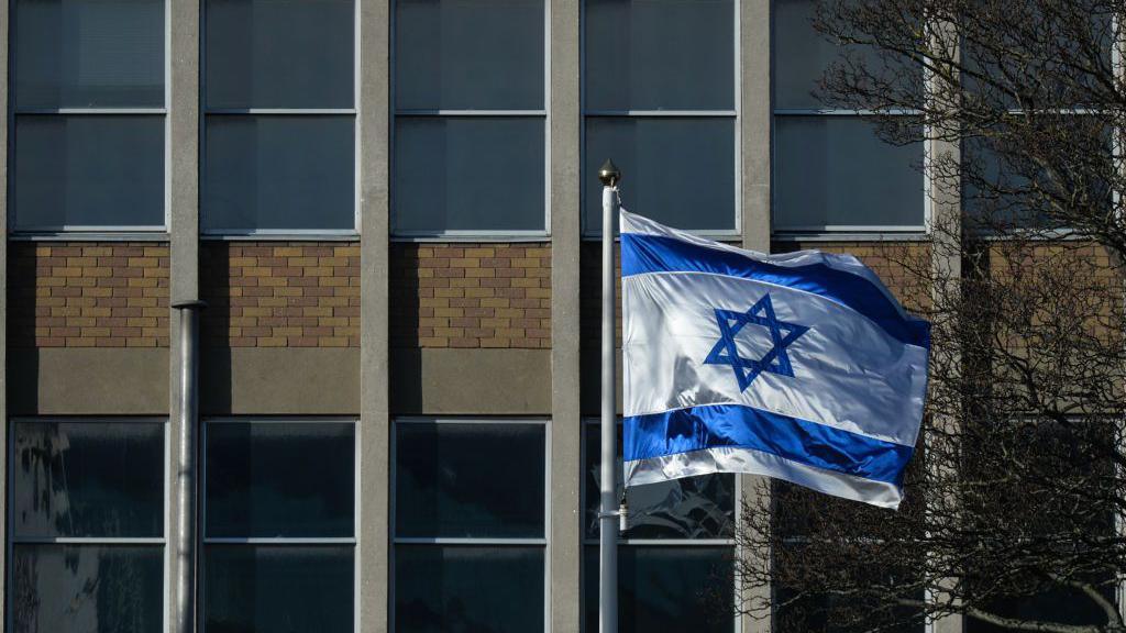 A view of the Israeli national flag in front of the Israeli Embassy in Dublin seen during Level 5 Covid-19 lockdown