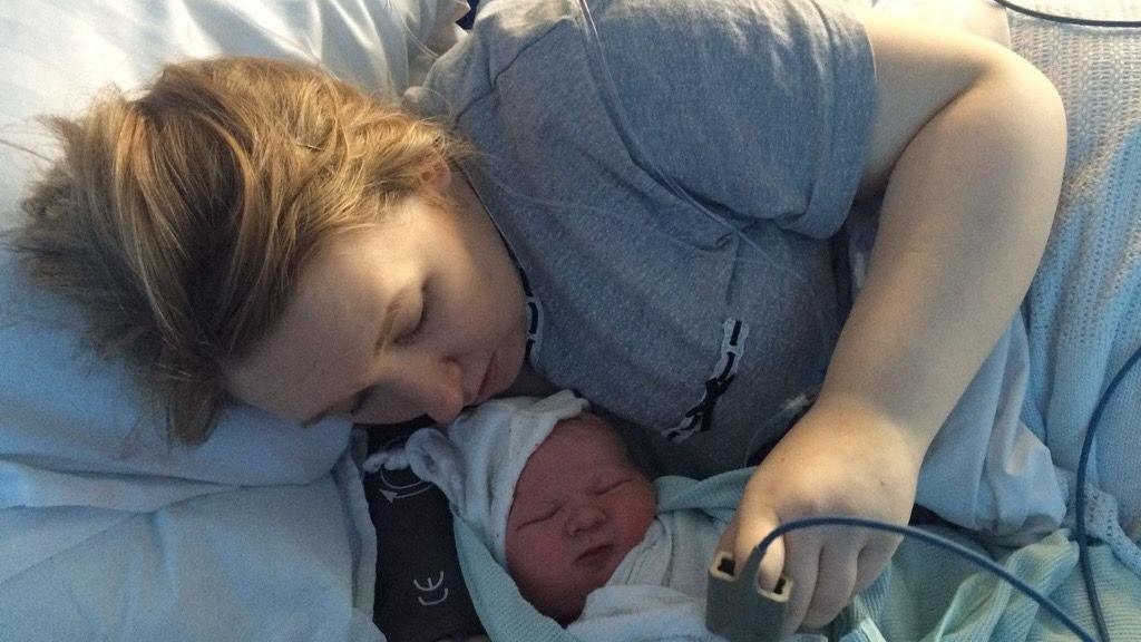 Rebecca Matthews in a hospital bed with her new born child.