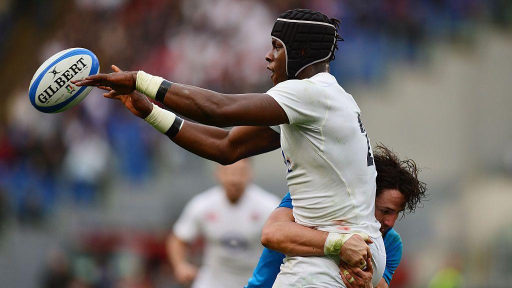 Maro Itoje offloads as he is tackled during a Six Nations game in 2016.