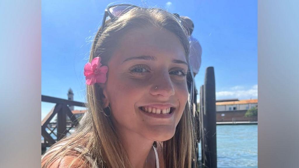 Juliette, pictured near the sea with a flower in her hair.