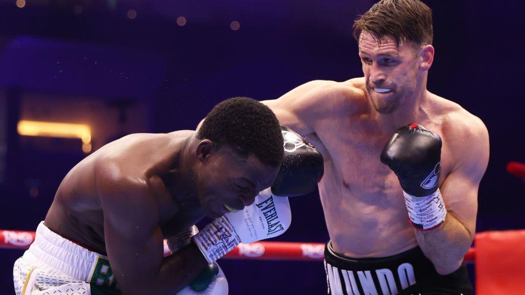 Joshua Buatsi dodges a punch from Callum Smith