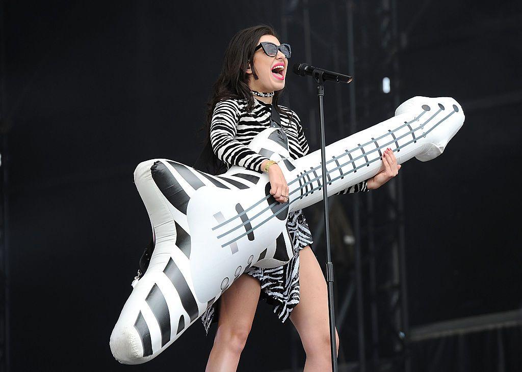 Charli XCX plays an inflatable guitar
