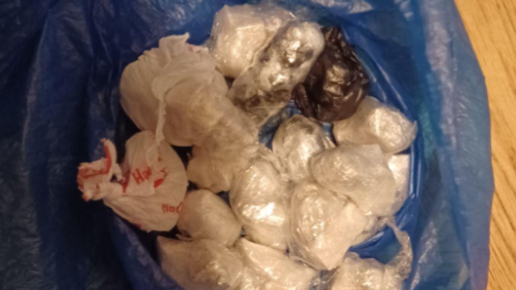 Small bags of cocaine and heroin in a blue plastic bag